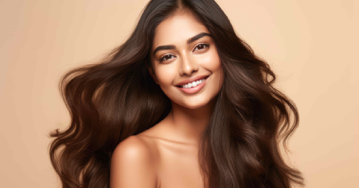 Smiling woman with long, voluminous, healthy hair showing the results of Hair Rejuvenation Therapy in Las Vegas, NV.